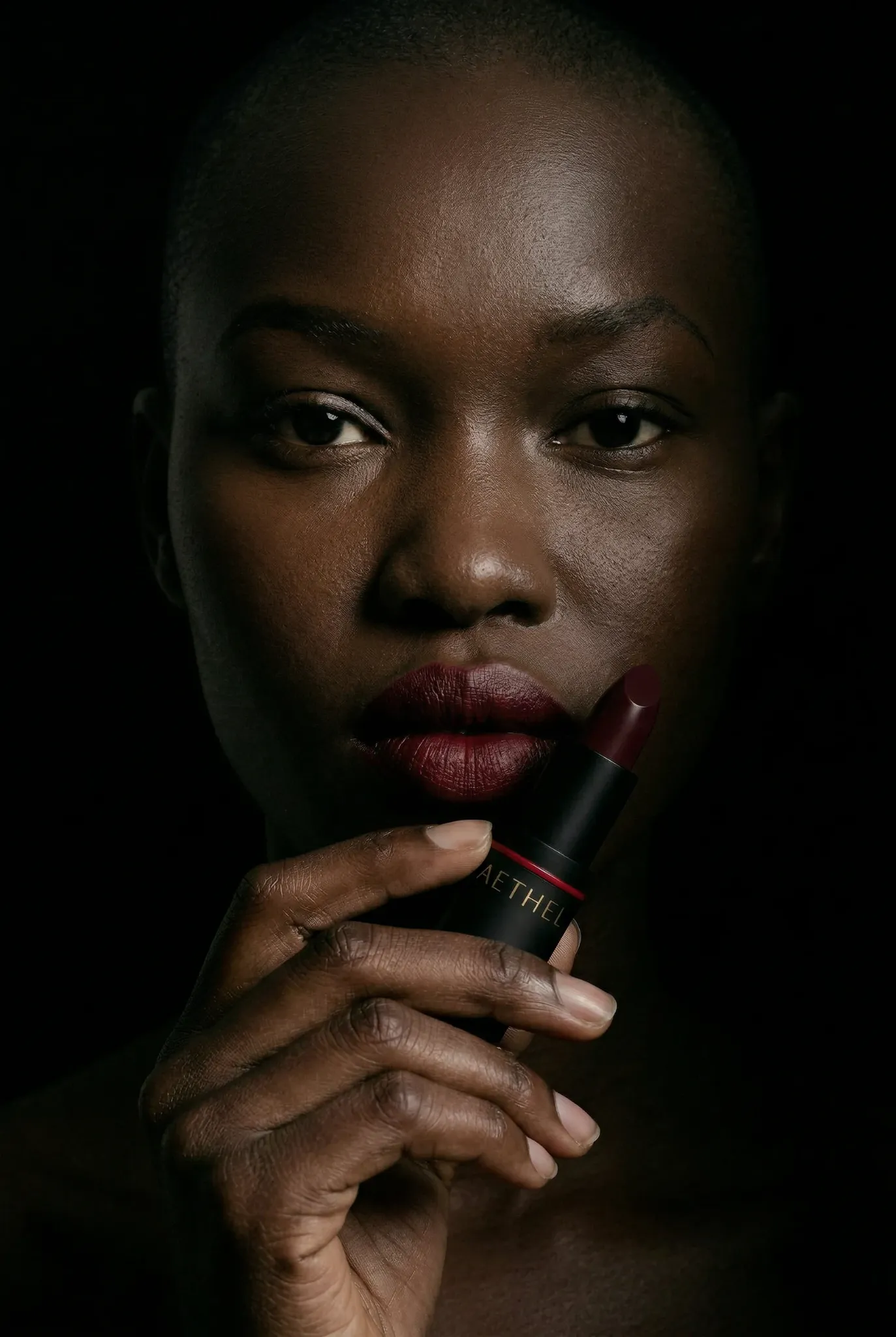 Beauty portrait holding Aethel lipstick